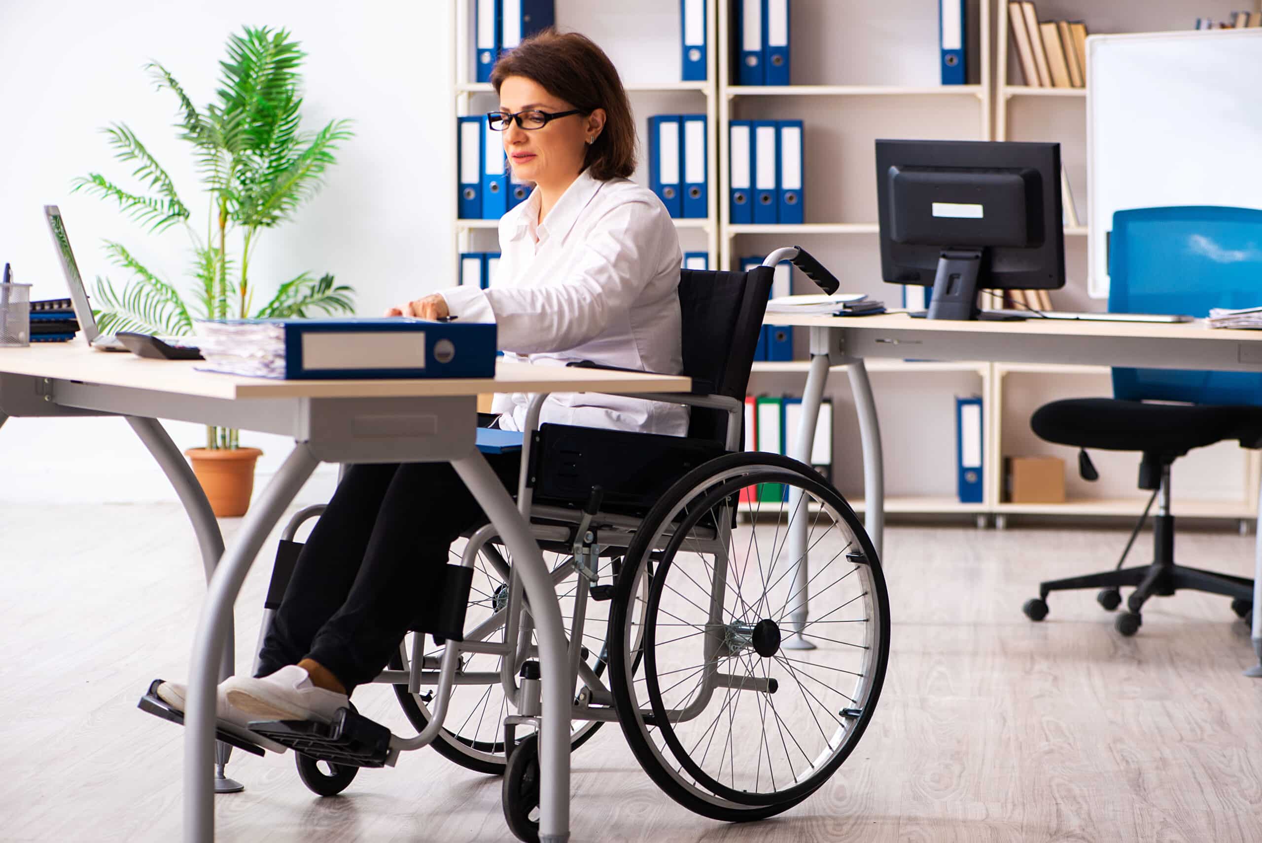 woman in wheelchair at work place