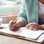 woman at desk writing