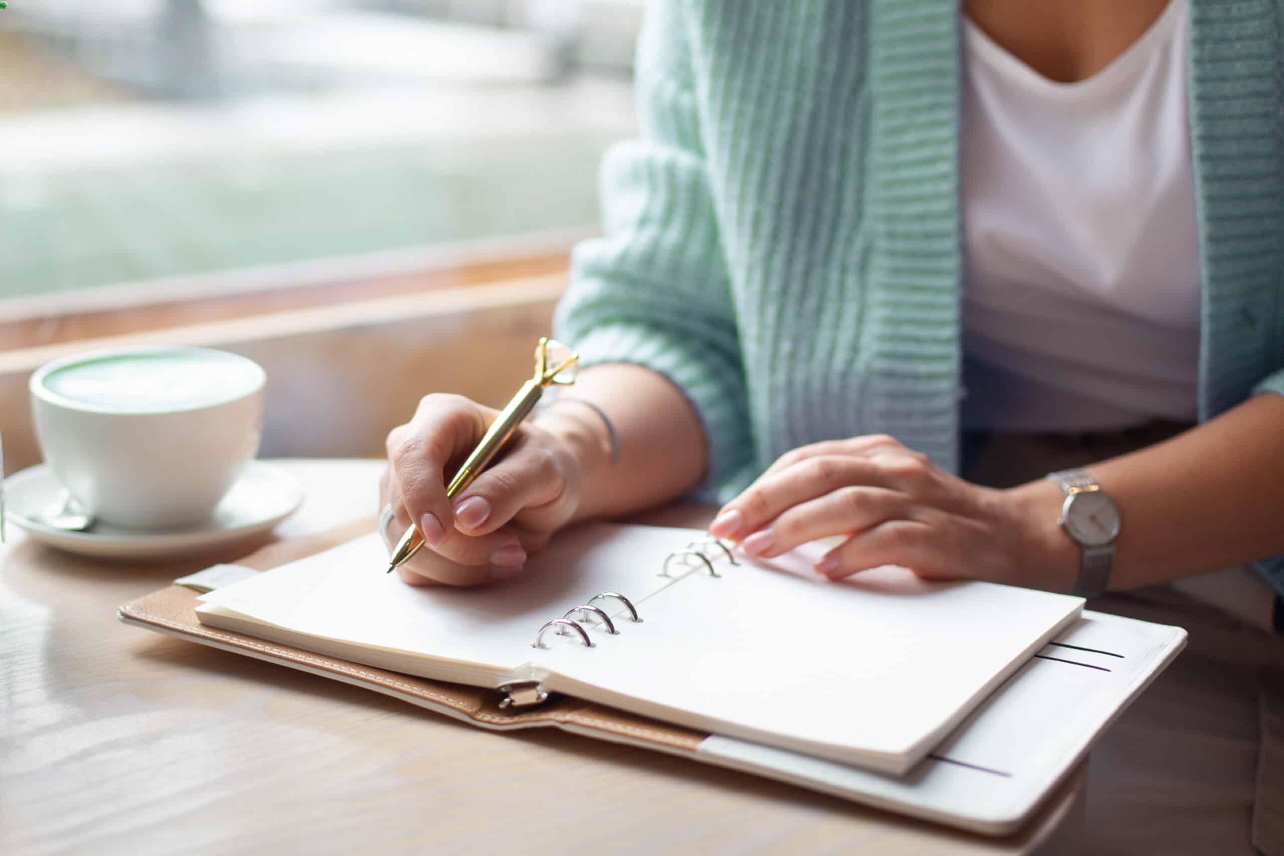 woman at desk writing